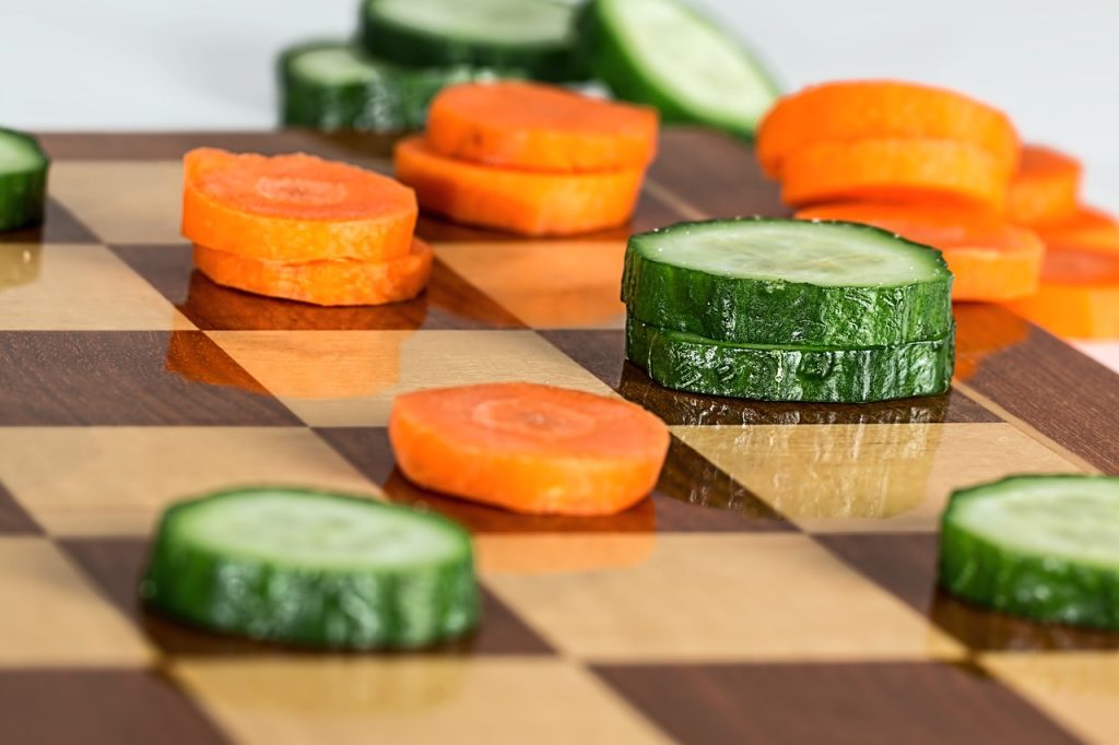 carrots and cucumber on chess board