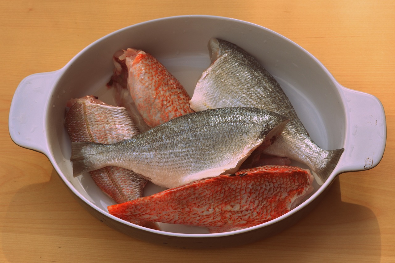 five fish sitting in a pan